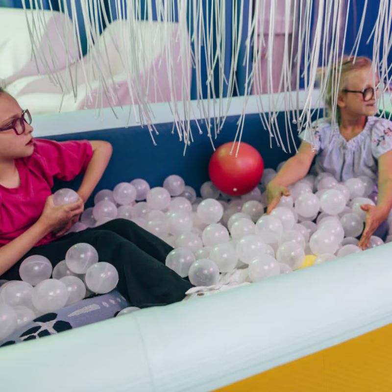 TFH Heavy Duty Inflatable Ball Pool in use during sensory play, showing children enjoying deep pressure and tactile input in a therapy room