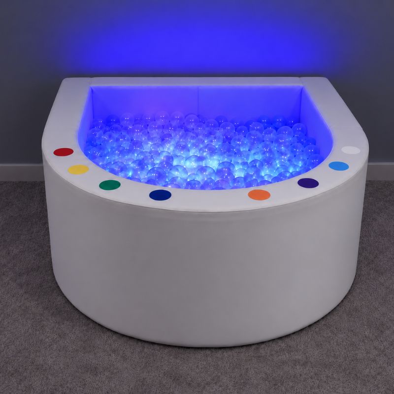 Front view of the Experia Interactive LED Ball Pool showing its color switches and blue-lit balls, a sensory room centerpiece
