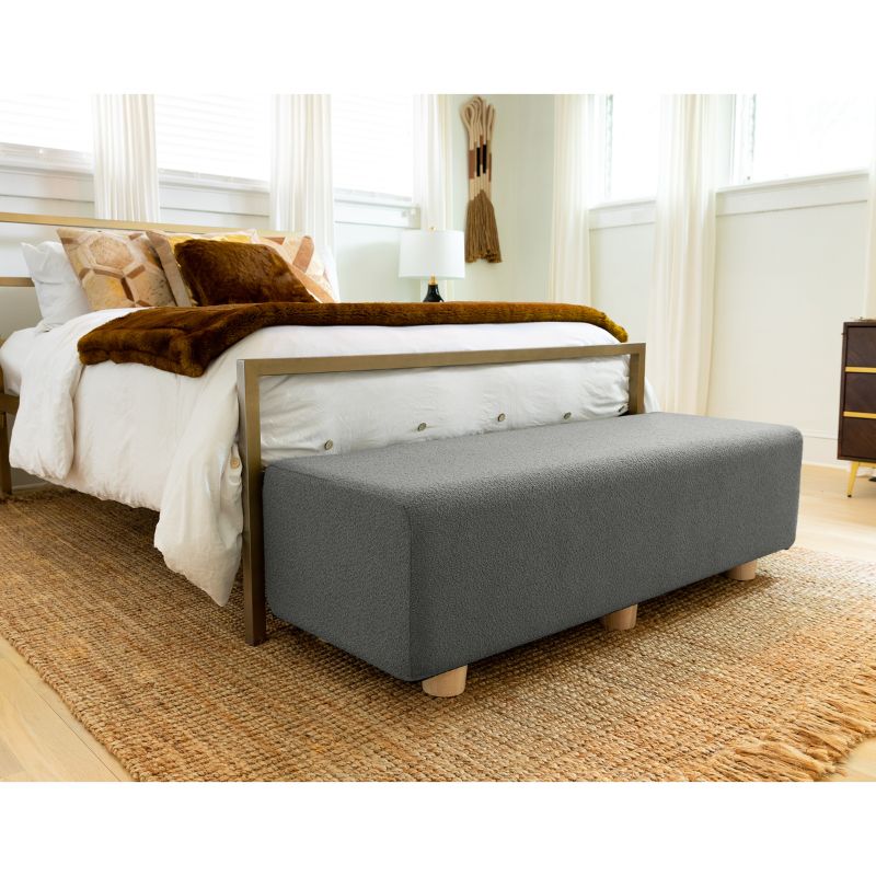 Jaxx Caya Boucle Bed Bench in dark grey styled at the foot of a bed, a flexible seating bench for bedrooms
