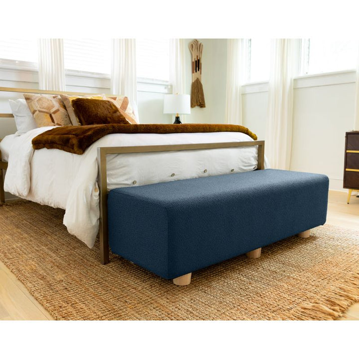 Jaxx Caya Boucle Bed Bench in navy styled at the foot of a bed, an end of bed bench for home seating