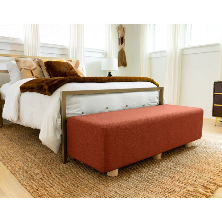 Jaxx Caya Boucle Bed Bench in terra cotta styled at the foot of a bed, a flexible seating bench for bedrooms