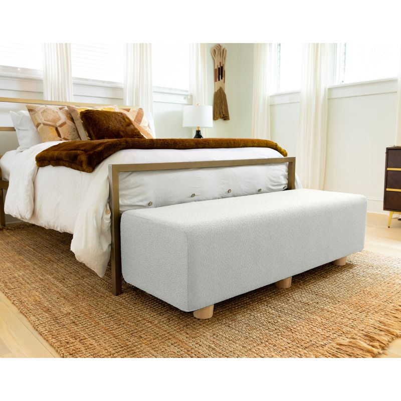 Jaxx Caya Boucle Bed Bench in white styled at the foot of a bed, an end of bed bench for home seating