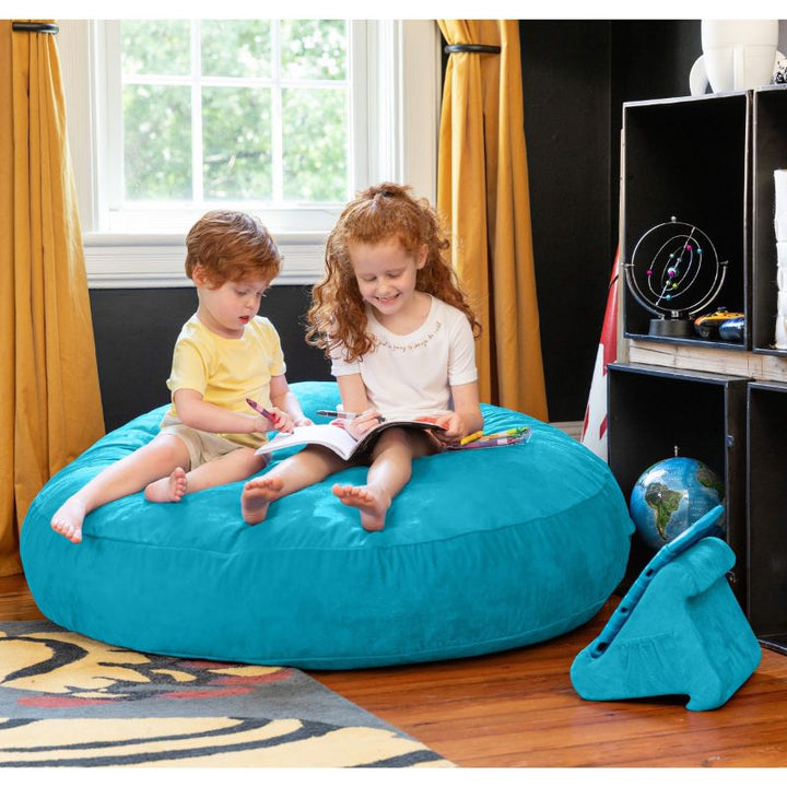 Two children reading together on an aqua Jaxx Cocoon 4ft kids bean bag chair, a calming deep pressure seat