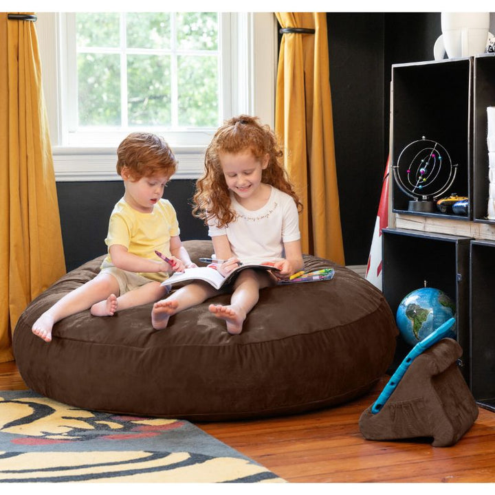 Two children reading together on a chocolate Jaxx Cocoon 4ft kids bean bag chair, a cozy sensory seat