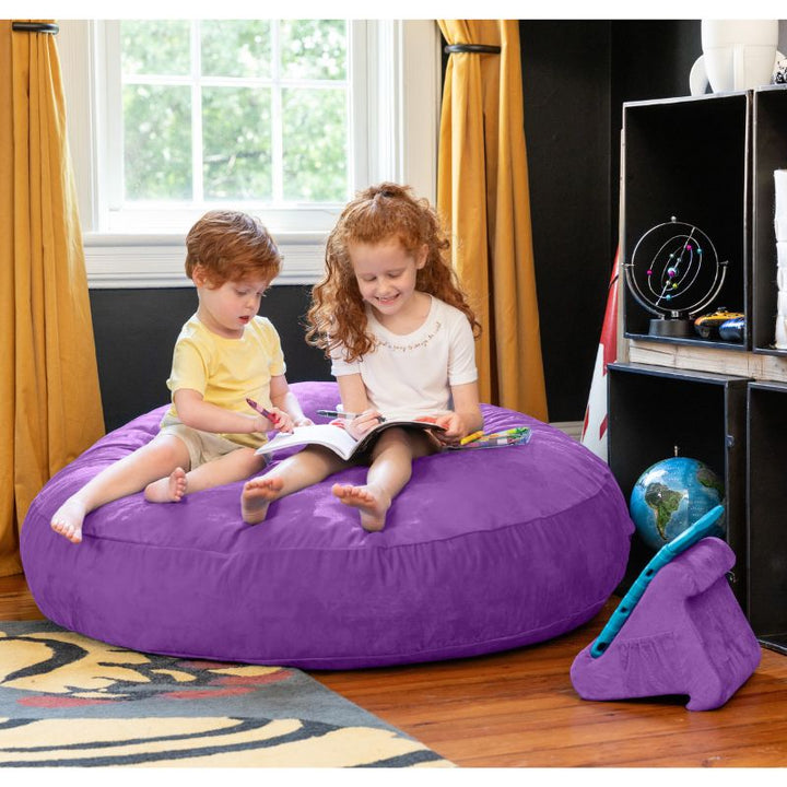 Two children reading together on a purple Jaxx Cocoon 4ft kids bean bag chair, a calming sensory crash pad