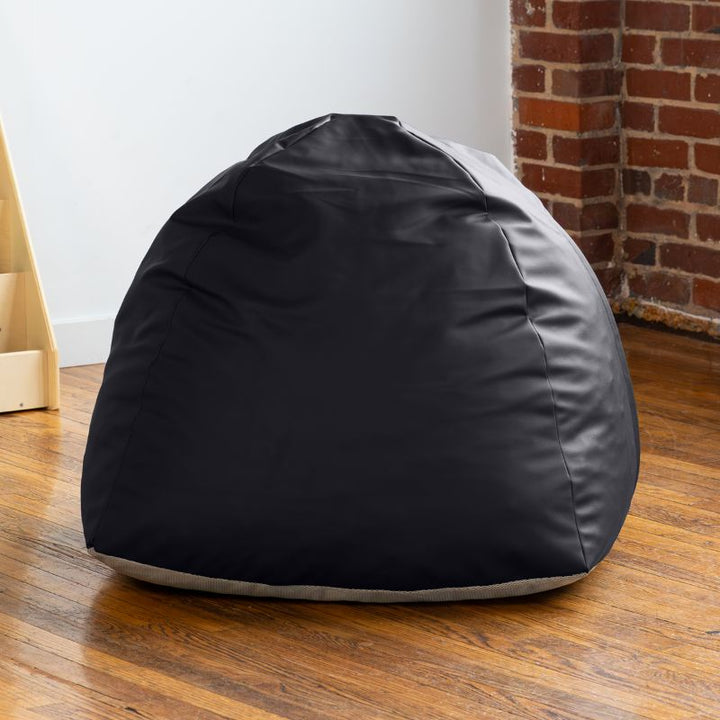 Empty black Jaxx Gumdrop bean bag chair in a classroom reading corner