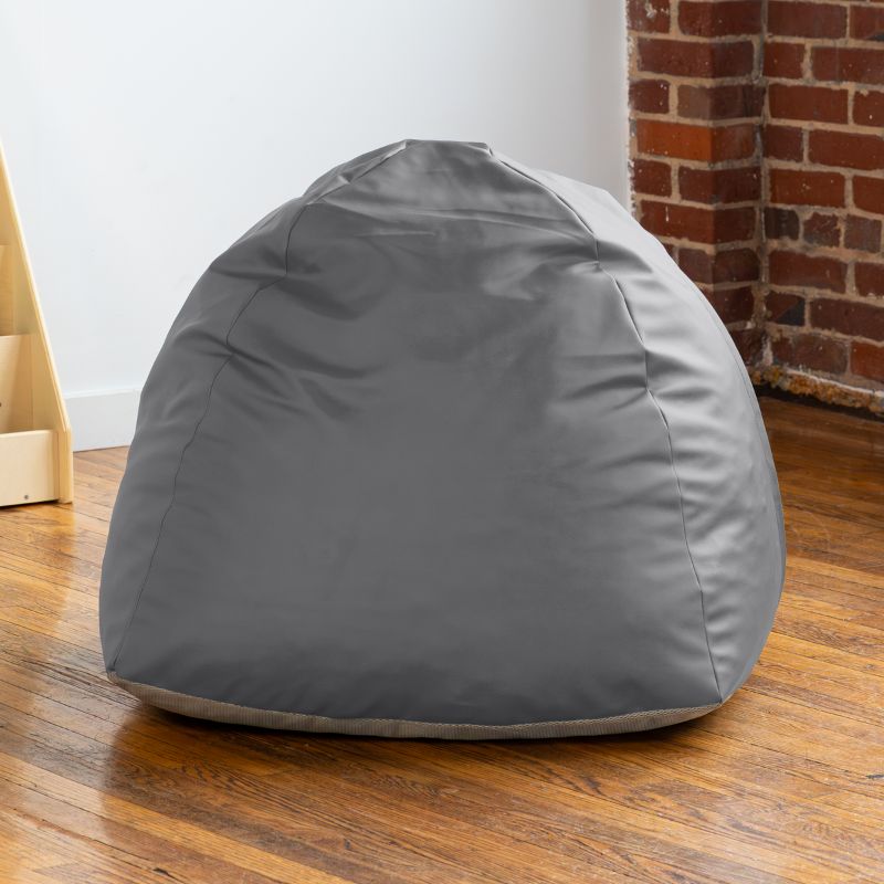 Empty charcoal Jaxx Gumdrop bean bag chair in a classroom reading corner