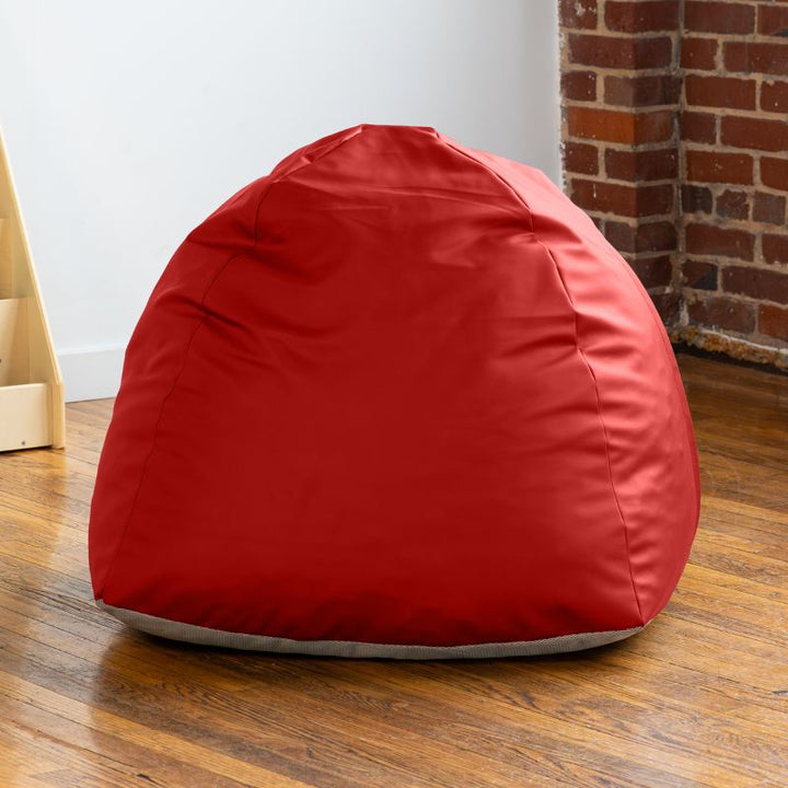 Empty red Jaxx Gumdrop bean bag chair in a classroom reading corner