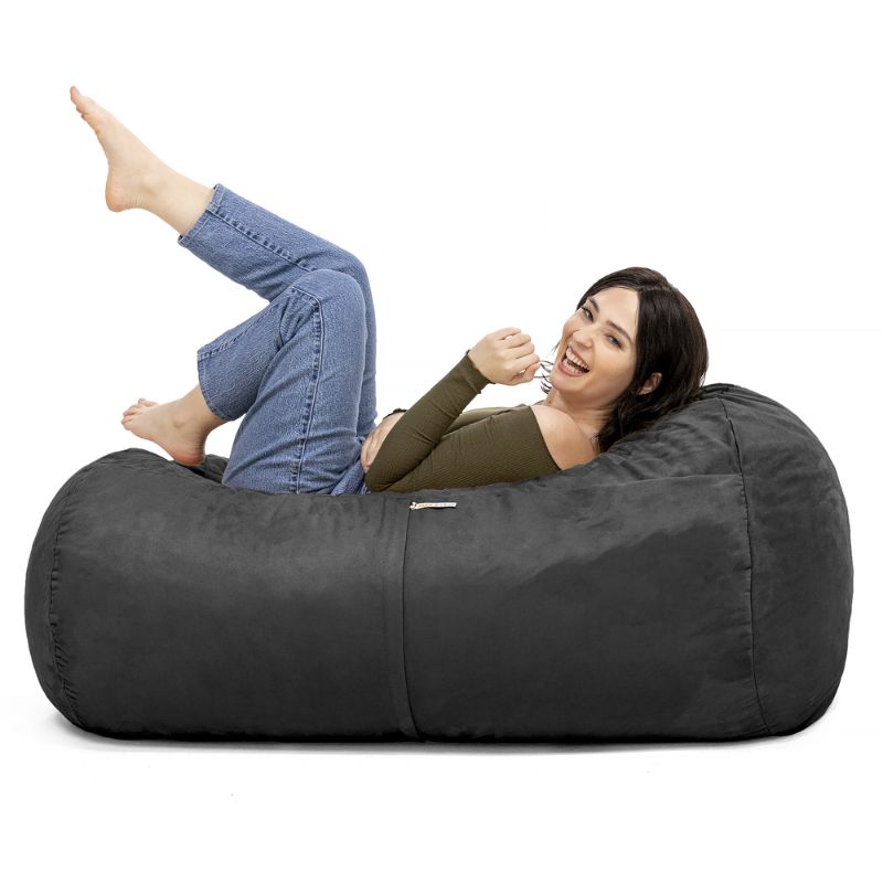 Woman relaxing on the Jaxx Lounger 4ft bean bag chair in Black microsuede, a washable deep pressure seat