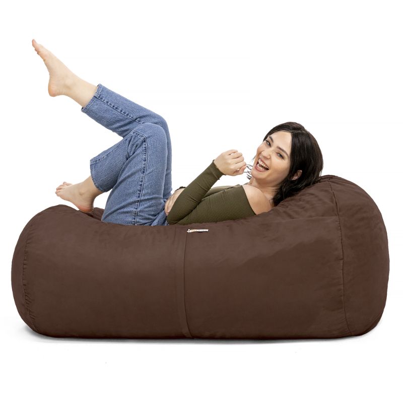 Woman relaxing on the Jaxx Lounger 4ft bean bag chair in Brown microsuede, a washable calm corner seat