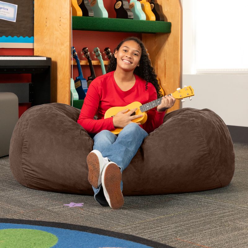 Teen playing ukulele on the Jaxx Lounger 4ft bean bag chair in Brown microsuede, a washable classroom seat