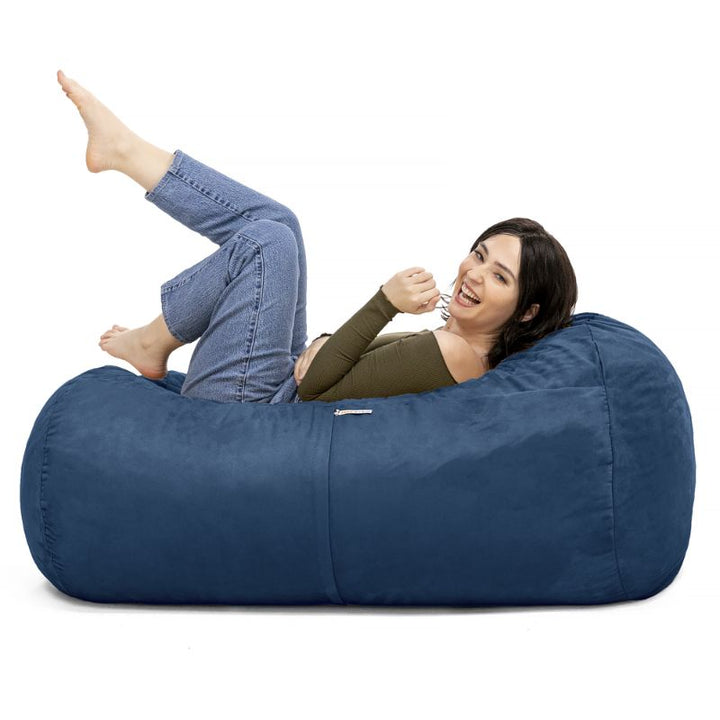 Woman relaxing on the Jaxx Lounger 4ft bean bag chair in Navy microsuede, a washable sensory seat
