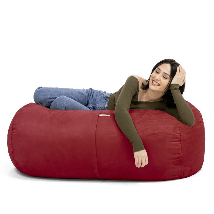 Woman leaning back on the Jaxx Lounger 4ft bean bag chair in Red microsuede, a washable deep pressure seat