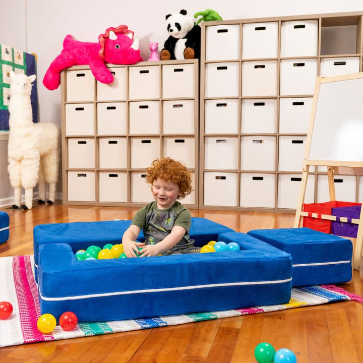 Jaxx Zipline kids convertible loveseat in blue microsuede arranged as a ball pit, a 3-in-1 play sofa for playrooms