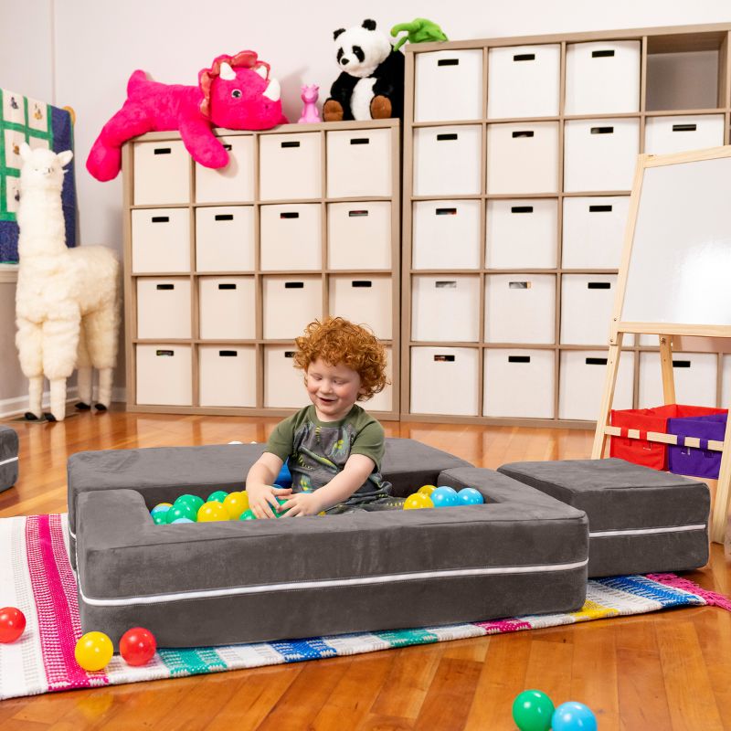 Jaxx Zipline kids convertible loveseat in charcoal microsuede arranged as a ball pit, a fold out play sofa for kids