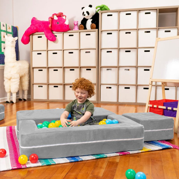 Jaxx Zipline kids convertible loveseat in grey microsuede arranged as a ball pit, a modular play sofa for imaginative play
