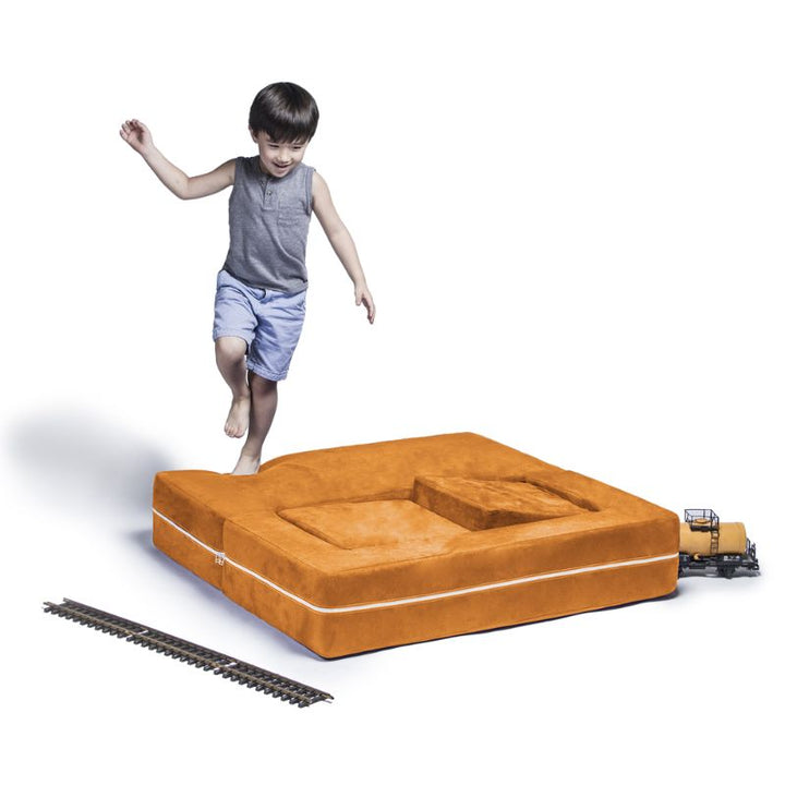 Jaxx Zipline kids convertible loveseat in orange microsuede in bed mode, a modular play sofa that folds flat for play