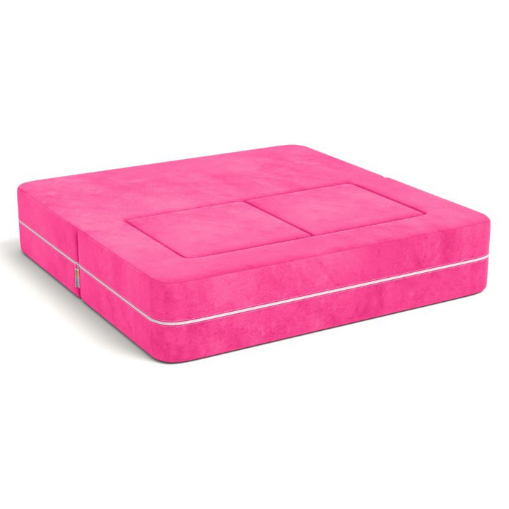 Jaxx Zipline kids convertible loveseat in pink microsuede folded into bed mode, a convertible play sofa for naps and sleepovers