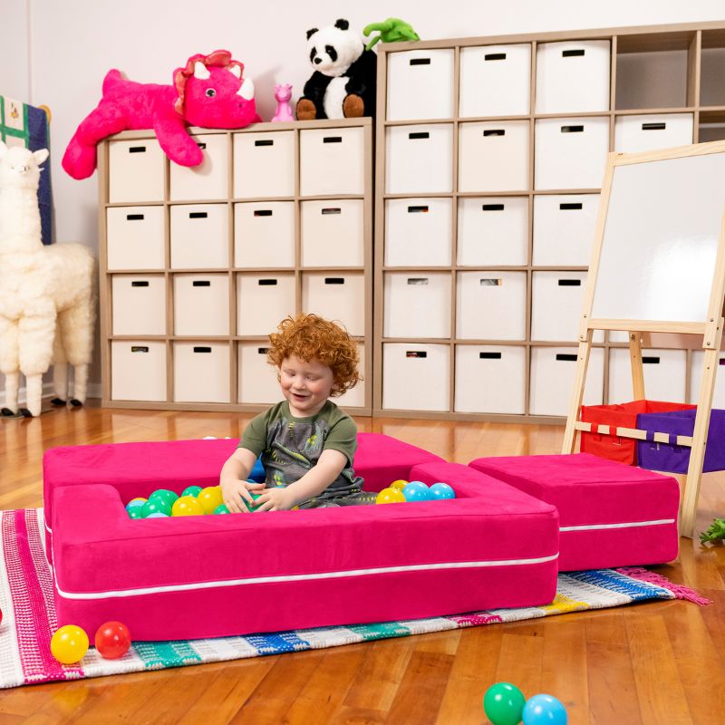 Jaxx Zipline kids convertible loveseat in pink microsuede arranged as a ball pit, a modular play sofa for playrooms