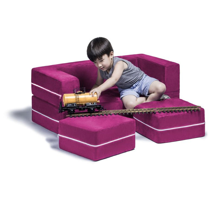 Jaxx Zipline kids convertible loveseat in pink microsuede in use as seating, a convertible play sofa for kids playrooms