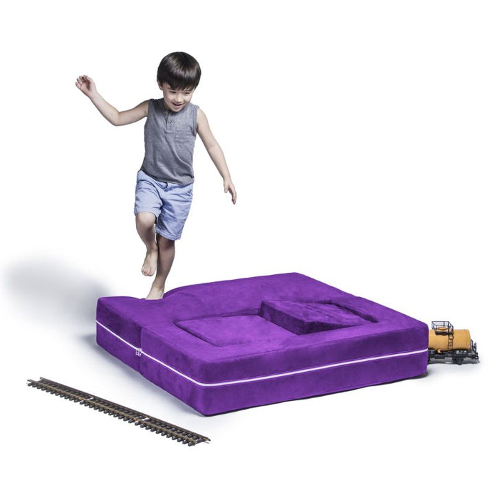 Jaxx Zipline kids convertible loveseat in purple microsuede in bed mode, a fold out play sofa that doubles as a daybed