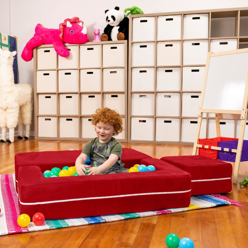 Jaxx Zipline kids convertible loveseat in red microsuede arranged as a ball pit, a convertible play sofa for active play
