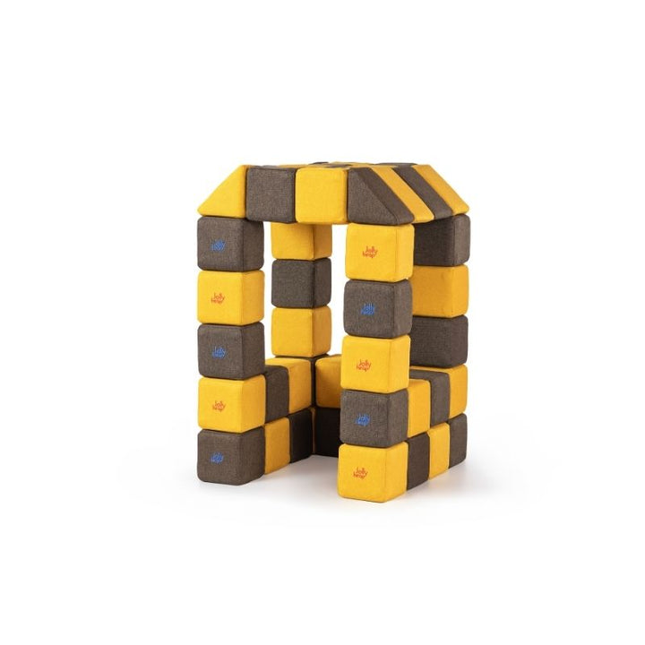 A tower and archway structure built from JollyHeap Medium Set magnetic soft blocks in a checkerboard pattern