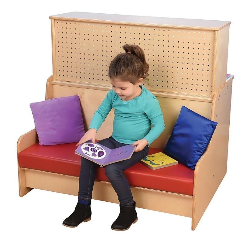 Child reading independently on the Jonti-Craft Literacy Station bench, showing the comfortable low seating of this early childhood literacy furniture for classrooms and home