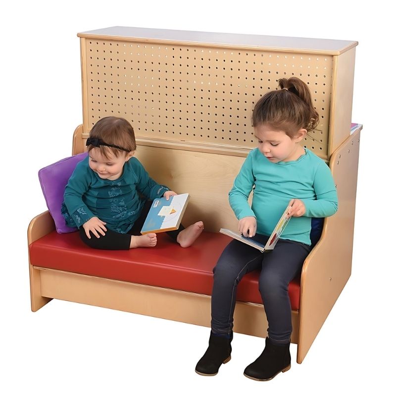 Two children seated together on the Jonti-Craft Literacy Station cushioned bench, showing the two-seater reading area of this classroom literacy and writing station