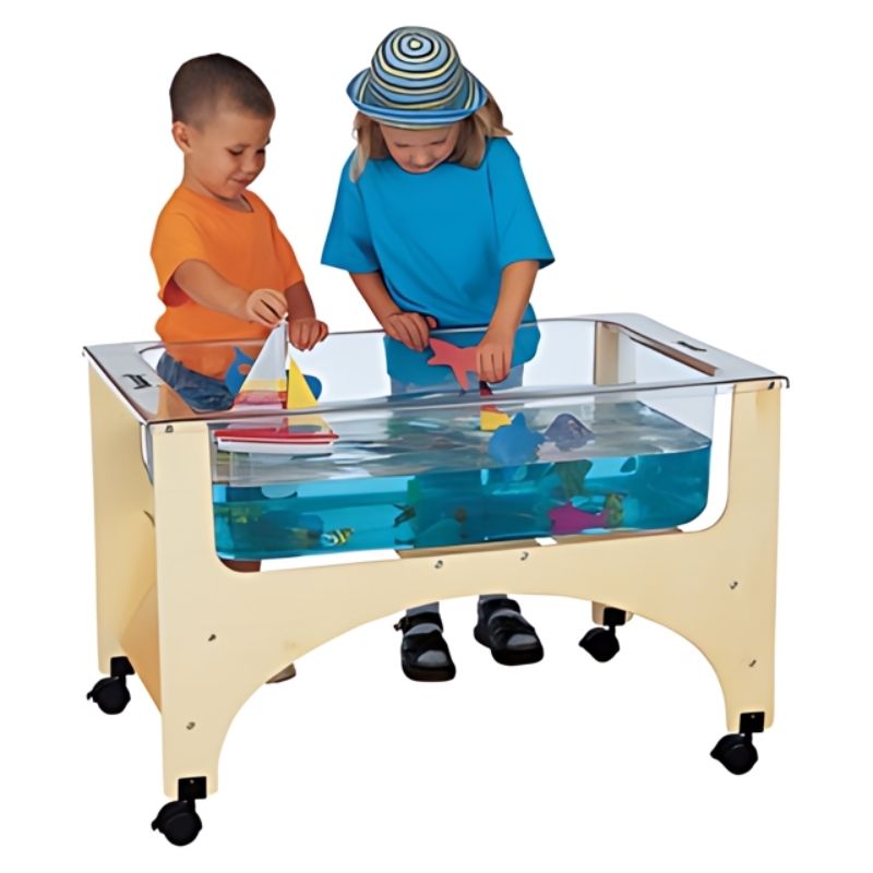 Child actively playing at the Jonti-Craft See Thru Sensory Table 24-1/2" High showing the clear acrylic 360-degree visibility tub at preschool-appropriate standing height