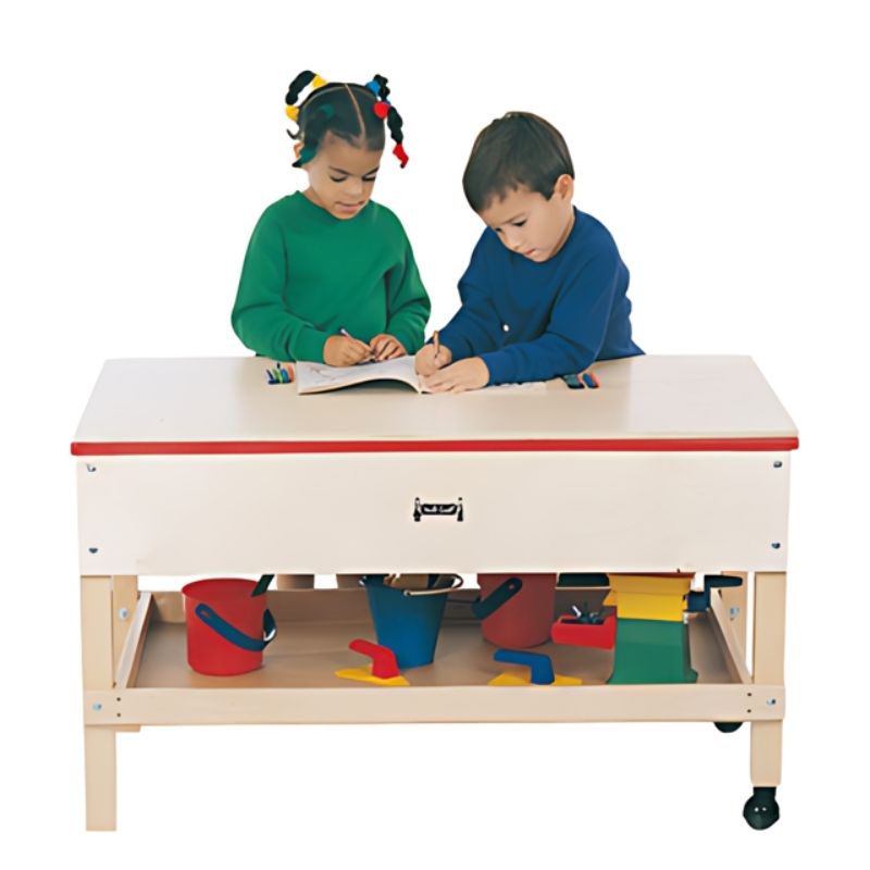 Two Children actively playing at the Jonti-Craft Sensory Table with Shelf 24" High showing the Baltic Birch frame, opaque plastic tub, and preschool standing height for classroom sensory play
