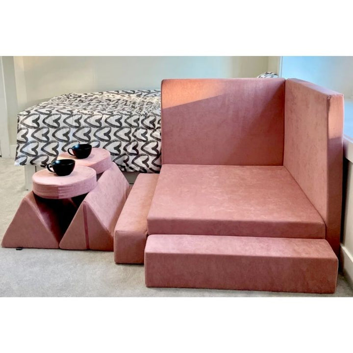Kiddie Couch in Blush Pink arranged in a custom play configuration, demonstrating the modular sensory play couch's build versatility