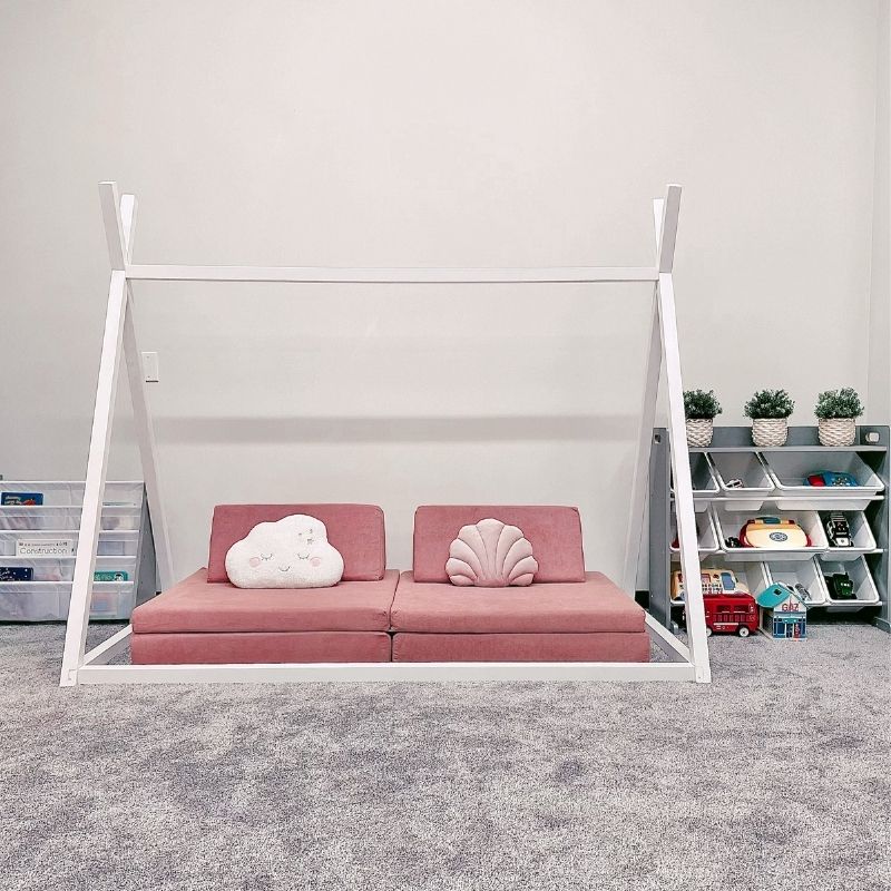 Front view of the Kiddie Couch in Blush Pink in a playroom showing the full assembled modular sensory play couch