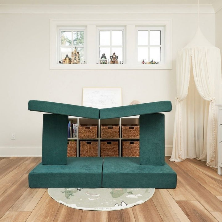 Kiddie Couch in Emerald Green built into a fort configuration, showing the modular play couch's imaginative sensory play possibilities