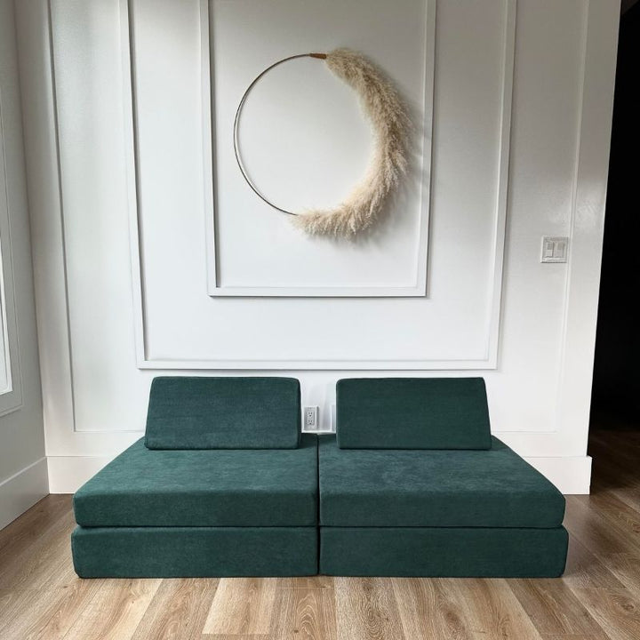 Front view of the Kiddie Couch modular play couch in Emerald Green showing the full assembled four-piece foam configuration