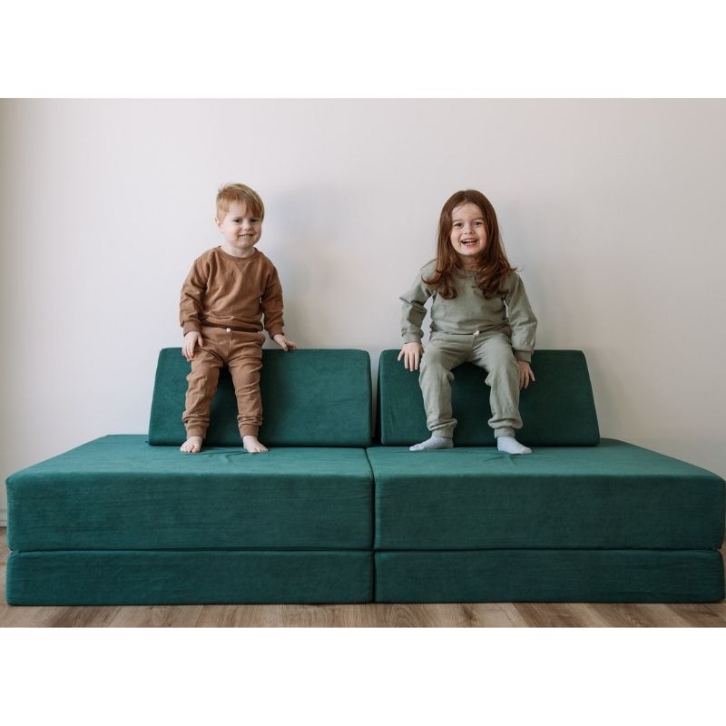 Two children playing on the Kiddie Couch in Emerald Green, showing active sensory and gross motor play with the modular couch