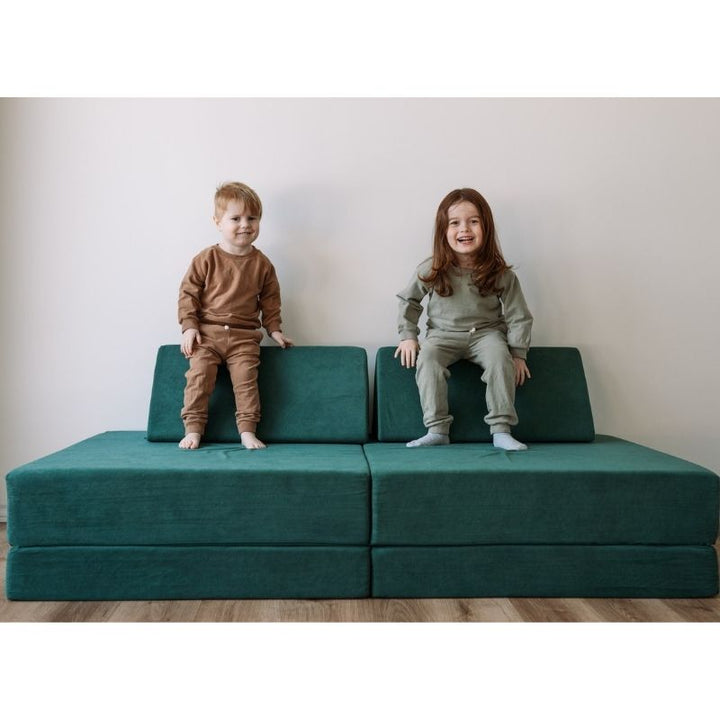 Two children playing on the Kiddie Couch in Emerald Green, showing active sensory and gross motor play with the modular couch