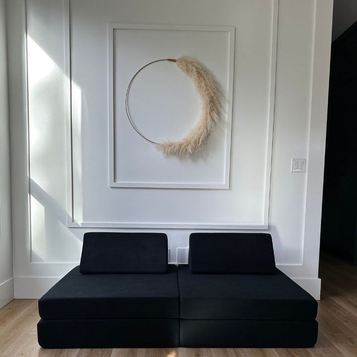 Front view of the Kiddie Couch modular play couch in Jet Black showing the assembled foam configuration with microvelvet cover