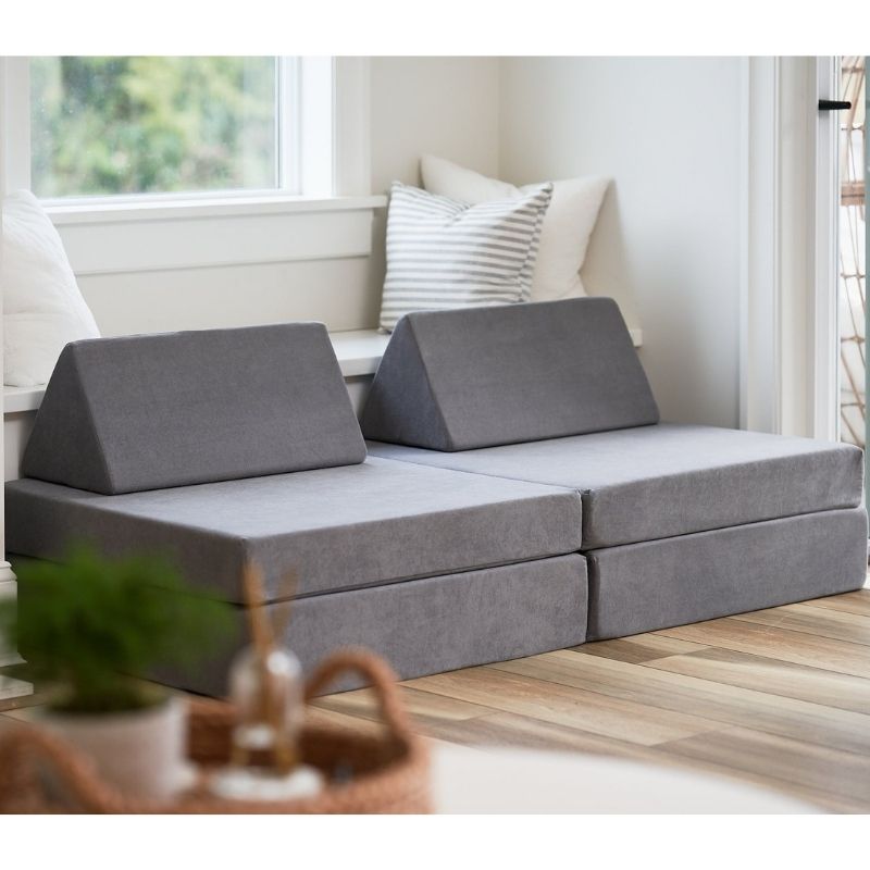 Angled view of the Kiddie Couch modular play couch in Koala Grey showing the four-piece foam assembly from the side