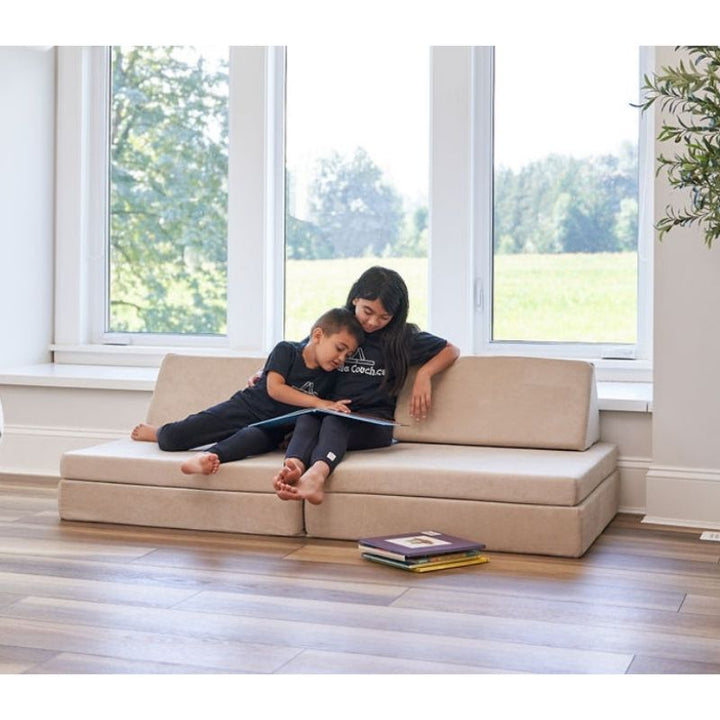 Children reading on the Kiddie Couch in Sand Beige, showing the play couch in a calm, quiet sensory play and relaxation setting