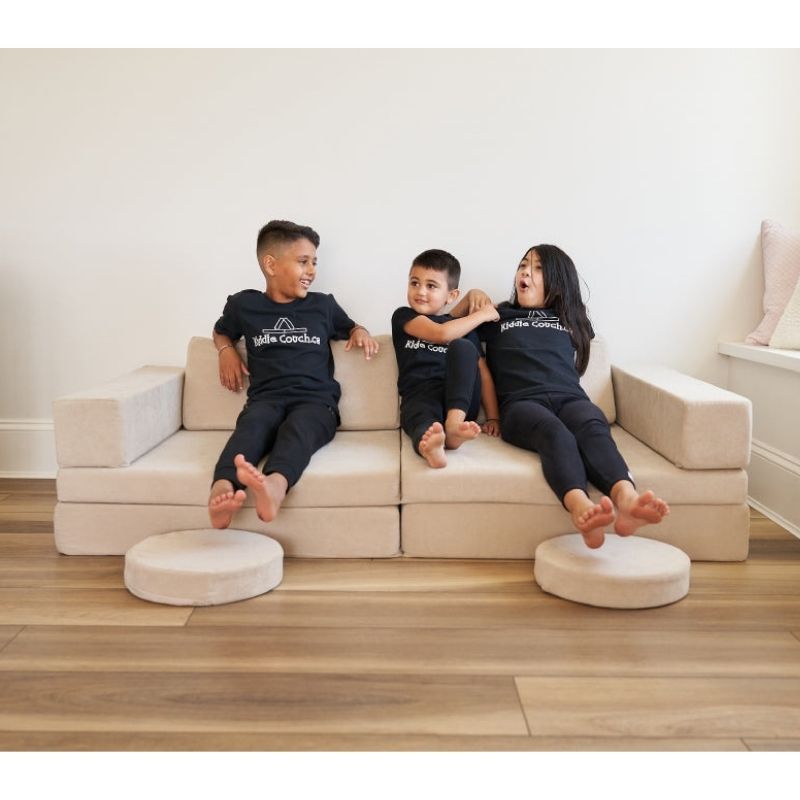 Children sitting together on the Kiddie Couch in Sand Beige, showing the play couch as comfortable everyday kids furniture