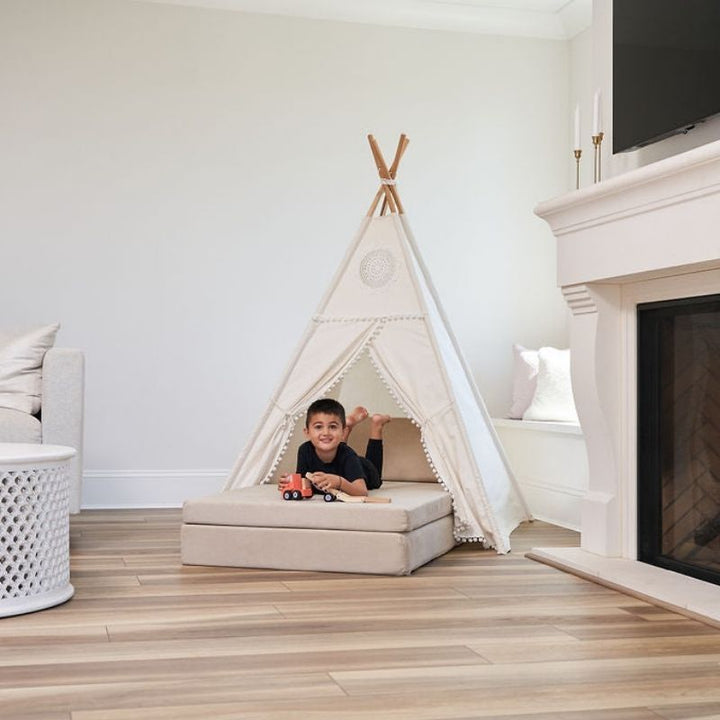 Kiddie Couch in Sand Beige arranged into a teepee configuration, demonstrating creative modular fort-building play