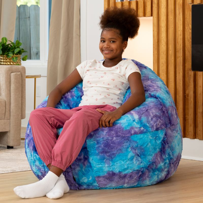 Child sitting upright in the Raven-Symoné Lil' Cuddler kids bean bag lounger in Lush Tie-Dye Fur Mystic Blue & Purple