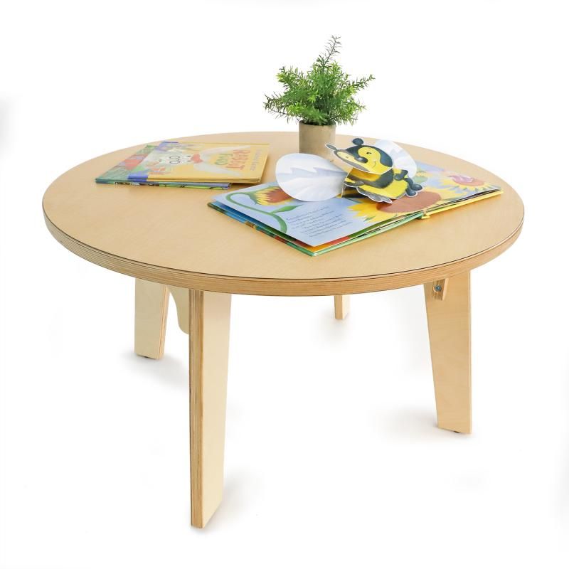 Open pop-up picture books and a small plant on the Whitney Brothers Whitney Plus Round Table, a 20 inch kids round table in birch plywood