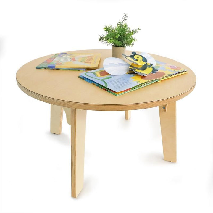 Open pop-up picture books and a small plant on the Whitney Brothers Whitney Plus Round Table, a 20 inch kids round table in birch plywood