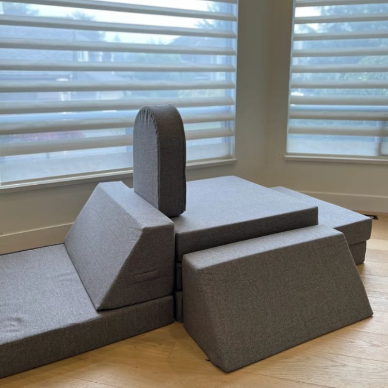 KiiCo Couch MAX in Mink colour variant configured indoors, showing the sophisticated polyester linen fabric and modular play couch layout in a home environment