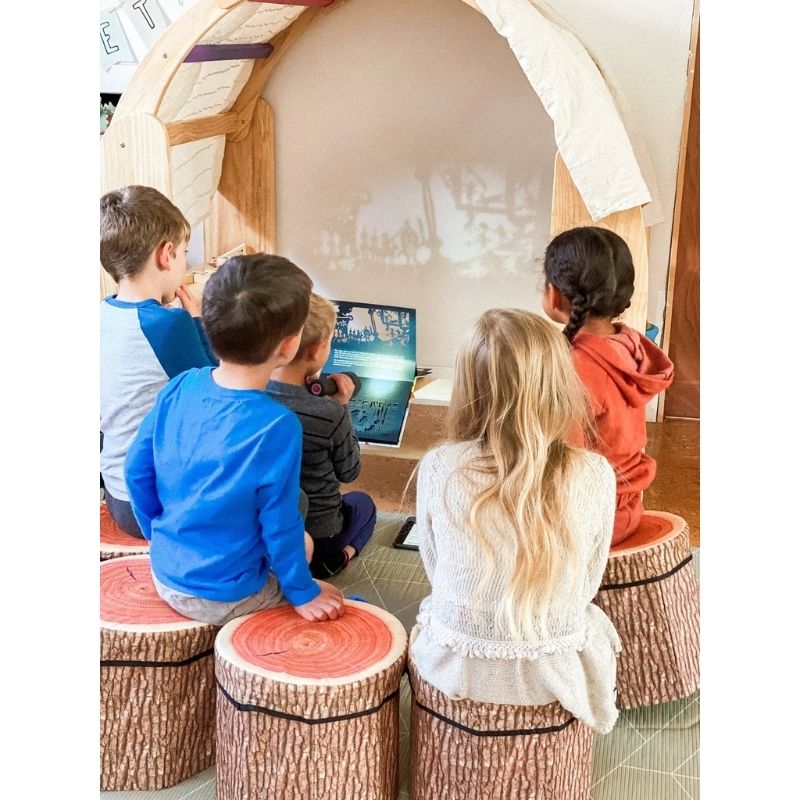 Two children watching and engaging with the Kinderhuis Aurora Waldorf Playstand, showing the playstand's suitability for group and social play