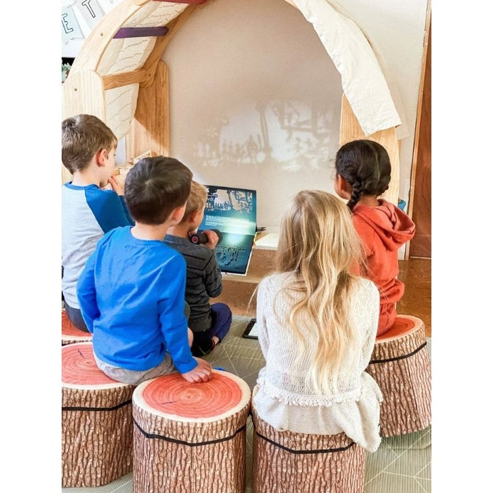 Two children watching and engaging with the Kinderhuis Aurora Waldorf Playstand, showing the playstand's suitability for group and social play