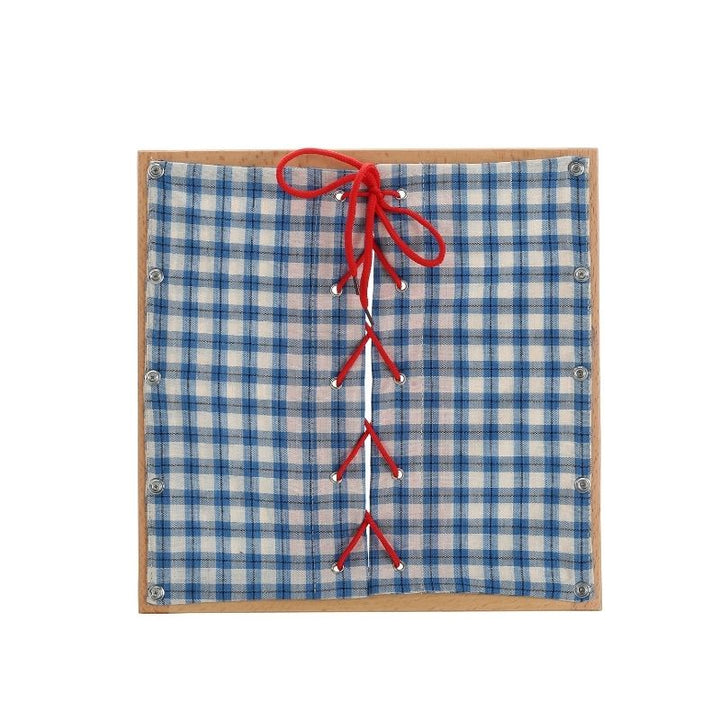 Kinderhuis Montessori dressing frame showing bow and knot closure, practical life material for self-dressing skill development