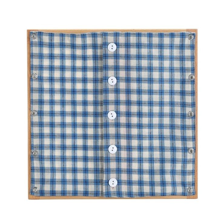 Kinderhuis Montessori dressing frame with white and blue fabric panel, AMI-approved beechwood material for fine motor skills